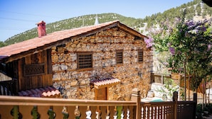 A stone house with a tiled roof, wooden door, and windows. - Ayşenaz Hanım Konağı (Akseki)