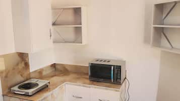 Apartament superior, pati, vistes a la platja | Cuina bàsica privada | Microones