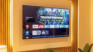 A flat-screen TV mounted on a wall with a wooden panel design. - The newest Luxury at the heart of Negombo. (Negombo)