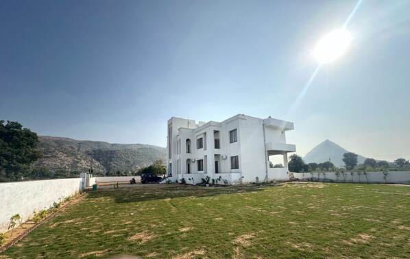 Situated on a well-maintained lawn, this building offers a serene mountain view.