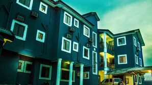 A multi-story building with a dark facade, multiple windows, and balconies. - Ididie Hotels (Yenagoa)