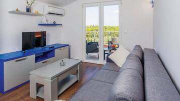 Apartment (One Bedroom Apartment) | Living room | 32-inch flat-screen TV with satellite channels