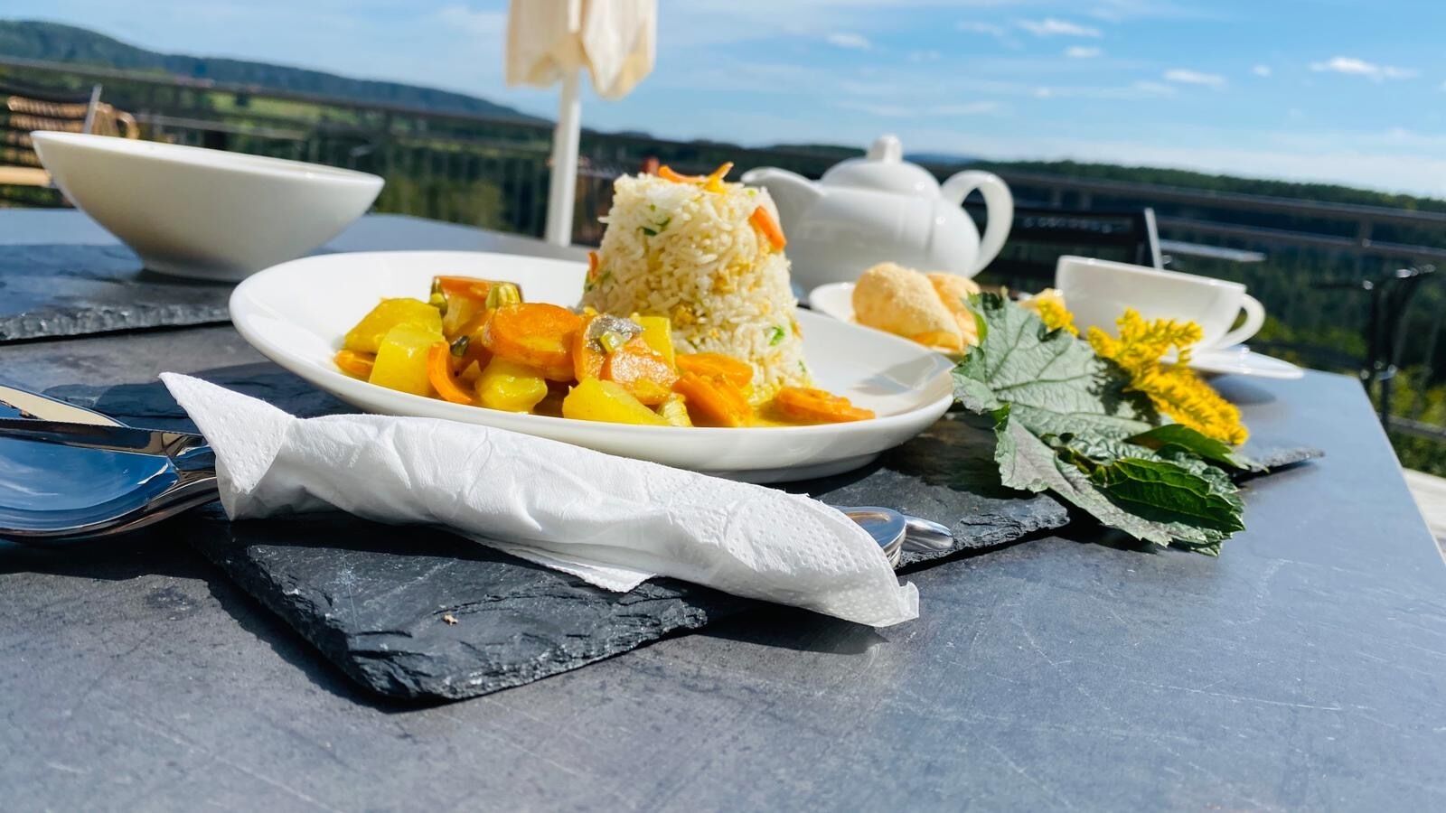 A meal on a table with a scenic view.