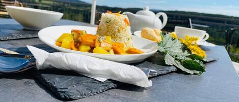 A meal on a table with a scenic view.