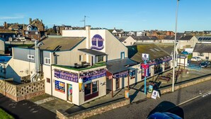 A restaurant with a signboard, a visible entrance, and a clear view of the street. - Sea Views Luxury Apartment Free Parking - Coast Ap (Arbroath)