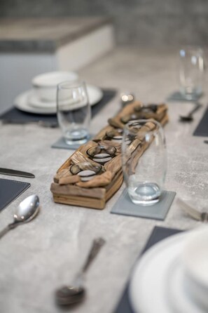 A table set with clear glassware, plates, and cutlery, suggesting a dining area. - Sea Views Luxury Apartment Free Parking - Coast Ap (Arbroath)