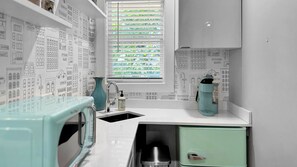 Fridge, microwave, coffee/tea maker, cookware/dishes/utensils