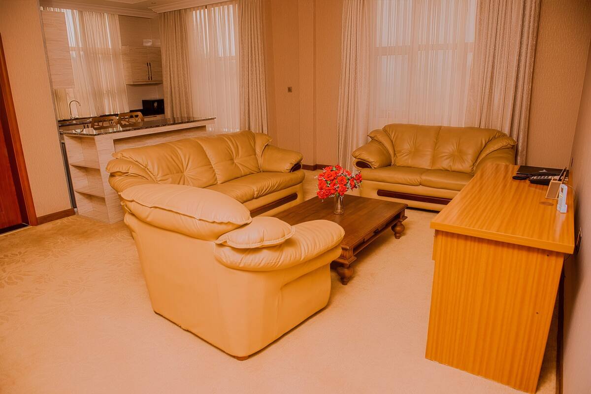 A living room with two sofas, a coffee table, and a wooden side table.