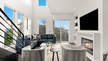 Smart TV, fireplace, books, computer monitors