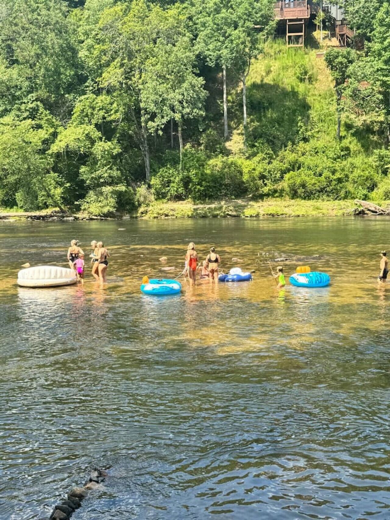 A river with people in inflatable rafts.