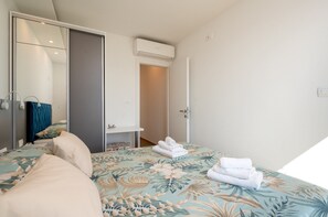A bedroom with a bed, a wardrobe, a mirror, and an air conditioning unit. - Exquisite and Stylish Apartment Trogir (Trogir)