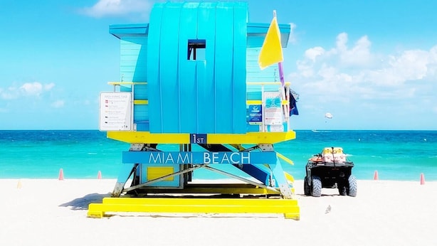 A lifeguard tower at Miami Beach with a clear blue sky and turquoise water. - Beach View at 101 Ocean Drive, SoFi in Miami Beach (Miami Beach)