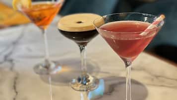 Three cocktails on a marble surface.