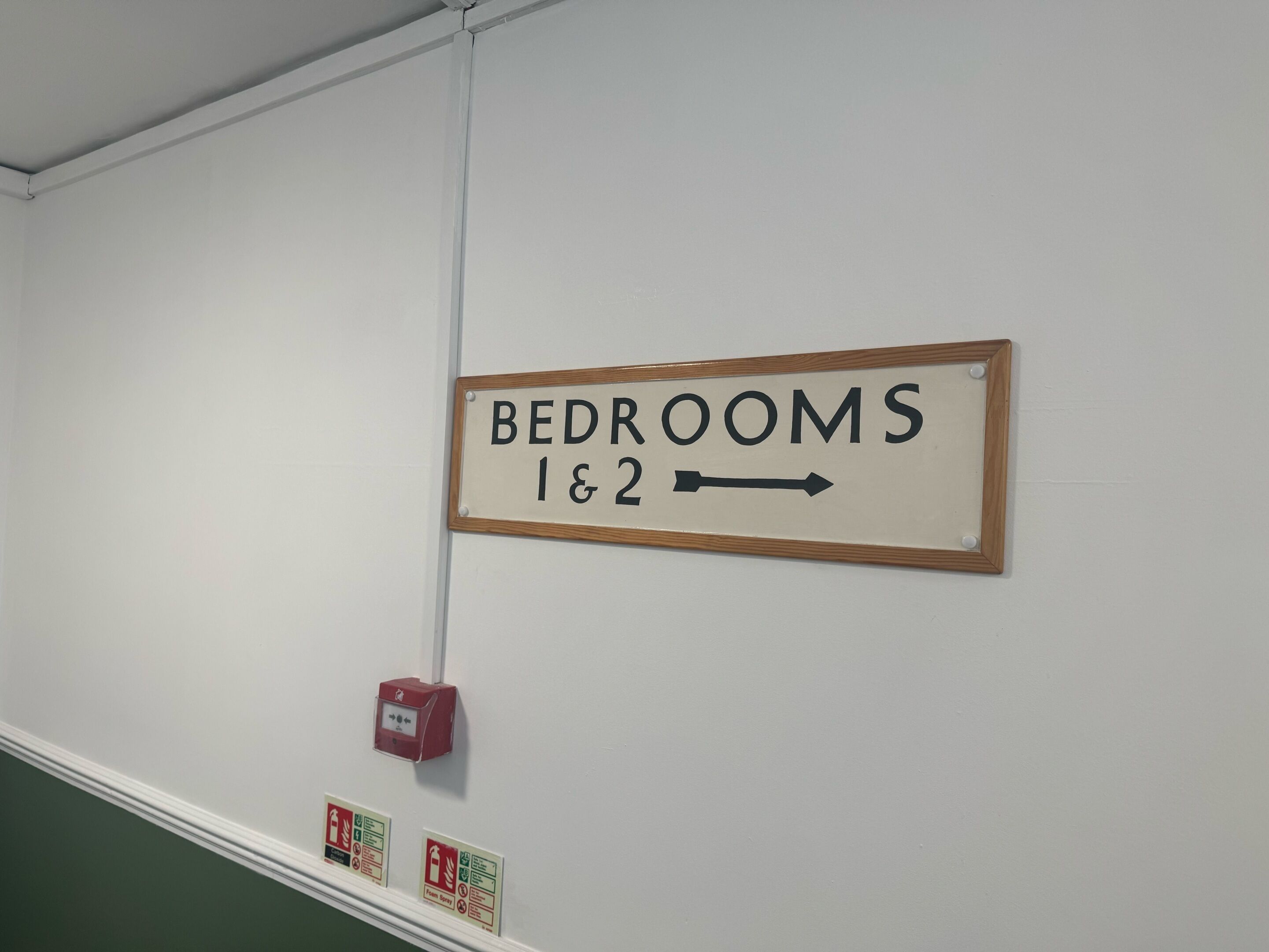 A sign indicating the direction to bedrooms 1 & 2.