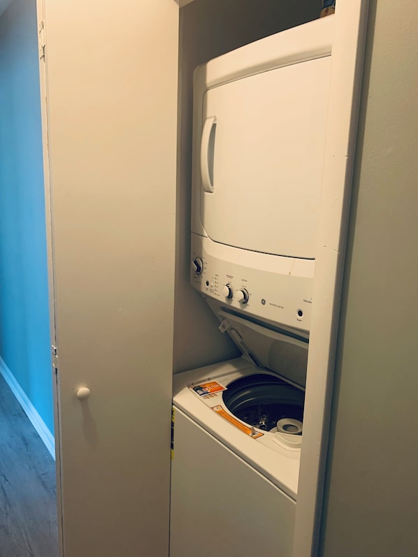 A front-loading washing machine with a control panel and a detergent dispenser.