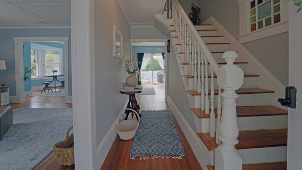 A staircase with white balusters and wooden steps leading to an upper floor. - Beautiful Modern Beach House In Old Orchard Beach! w/ optional In-Law Apartment! (Old Orchard Beach)
