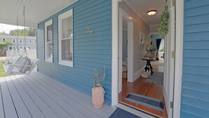 A blue house with a porch, a swing, and a potted plant. - Beautiful Modern Beach House In Old Orchard Beach! w/ optional In-Law Apartment! (Old Orchard Beach)
