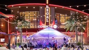 A building with a marquee sign reading 'REGAL CINCINNATI' and a stage with musicians performing. - Pet-Friendly Family Home w/ Yard (Gainesville)