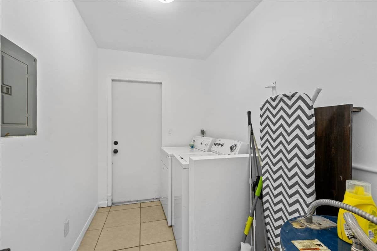 13. Laundry room with Washer and Dryer. Cleaning tools and ironboard