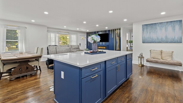 A modern kitchen with blue cabinets, a white countertop, and a built-in stove. - Cozy Decatur Home with Indoor Fireplace & Firepit (Decatur)