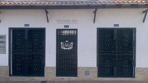 Three black doors with the Valymar Inn logo, each marked with a number (10-50, 10-48, 10-44). - Valymar Inn (Cali)