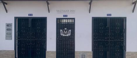 Three black doors with the Valymar Inn logo, each marked with a number (10-50, 10-48, 10-44).