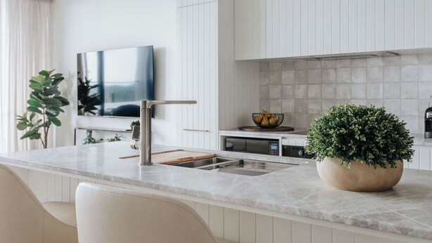 A modern kitchen with white cabinetry, a marble countertop, and a built-in oven. - Sunlit Sorrento Splendour in Position Perfect (Sorrento)