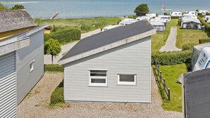 A row of mobile homes with a view of the sea and hills in the background. - 8 Person Holiday Park Home in Faaborg (Faaborg)