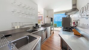 A modern kitchen with stainless steel appliances, a coffee maker, and wine racks. - Jasmine Waterslide 3-Bedrooms Villa (Chang Wat Surat Thani)