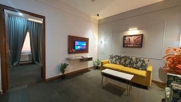 Luxury Studio Suite, City View | Living area | TV, printers