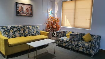 Luxury Studio Suite, City View | Living area | TV, printers