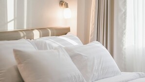 A neatly made bed with white linens in a hotel room. - Eng Fah Luang Hotel (Chiang Rai)