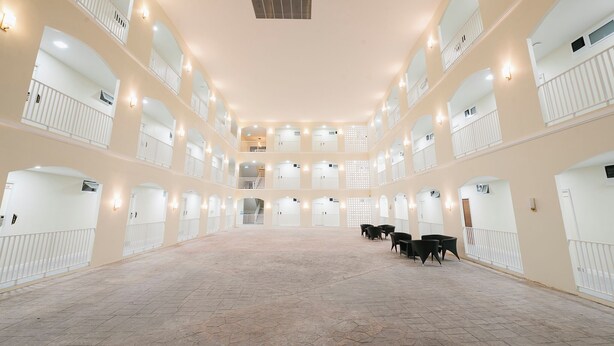 A spacious multi-level atrium with a tiled floor, multiple balconies, and seating areas. - Eng Fah Luang Hotel (Chiang Rai)