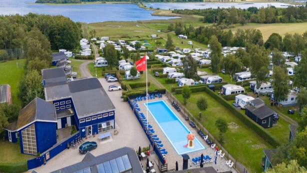 A campsite with RVs and a swimming pool. - 6 Person Holiday Park Home in Vipperod (Vipperod)