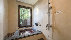 A bathroom with a window, a shower, and a small stool. - BEIJING DASEIN HOTEL (Beijing)