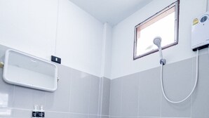 A small, modern bathroom with a toilet, sink, and shower. - GO INN Night Bazaar Chiang Mai (Chiang Mai)