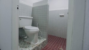 A small bathroom with a toilet, a shower, and a tiled floor. - GO INN Maya Chiang Mai (Chiang Mai)