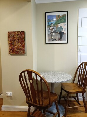 Enjoy meals in this cozy dining area with a round table and two classic chairs.