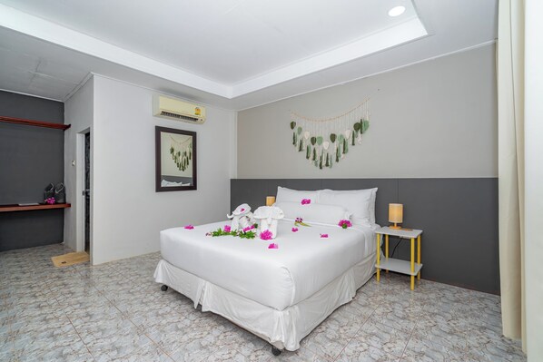 Un dormitorio ordenado con cama, mesita de noche y un adorno en la pared.