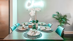 A dining table set with plates, napkins, and a centerpiece. - Game Room and Skydeck - Book Today (Nashville)