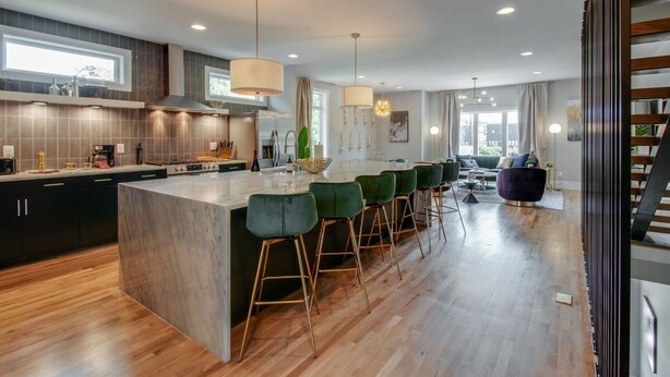 A modern kitchen with a large island, bar stools, and pendant lighting. - Large Group Lux 3mi Downtown - Rooftop City Views (Nashville)