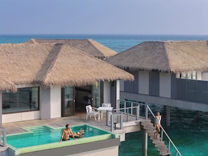 A resort with overwater bungalows, a swimming pool, and a dining area. - Noku Maldives, Vignette Collection by IHG (Kudafunafaru)