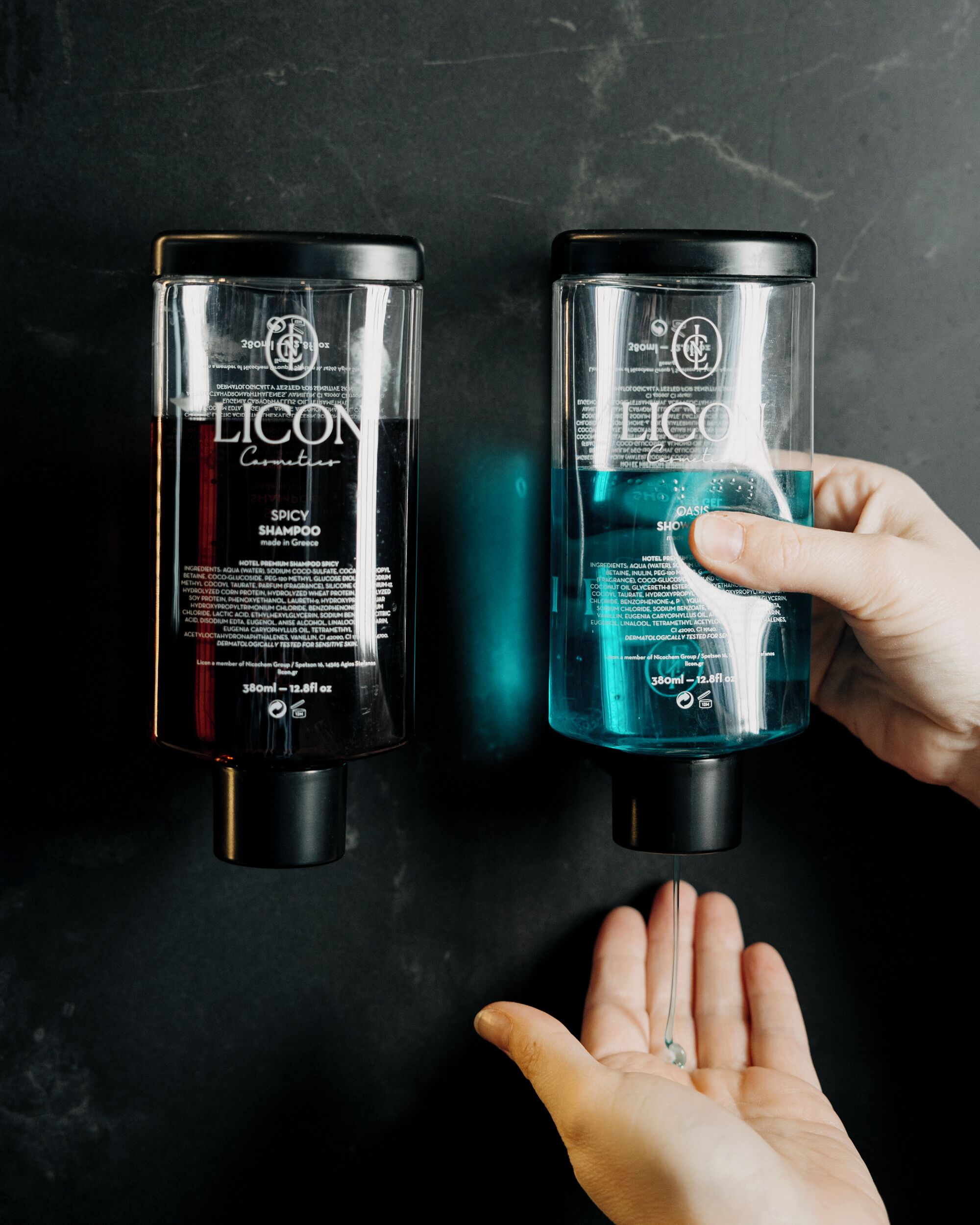 Two LICO shampoo bottles, one with a red label and the other with a blue label, on a dark surface.
