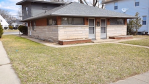 A two-story house with a front porch, a garage, and a satellite dish.