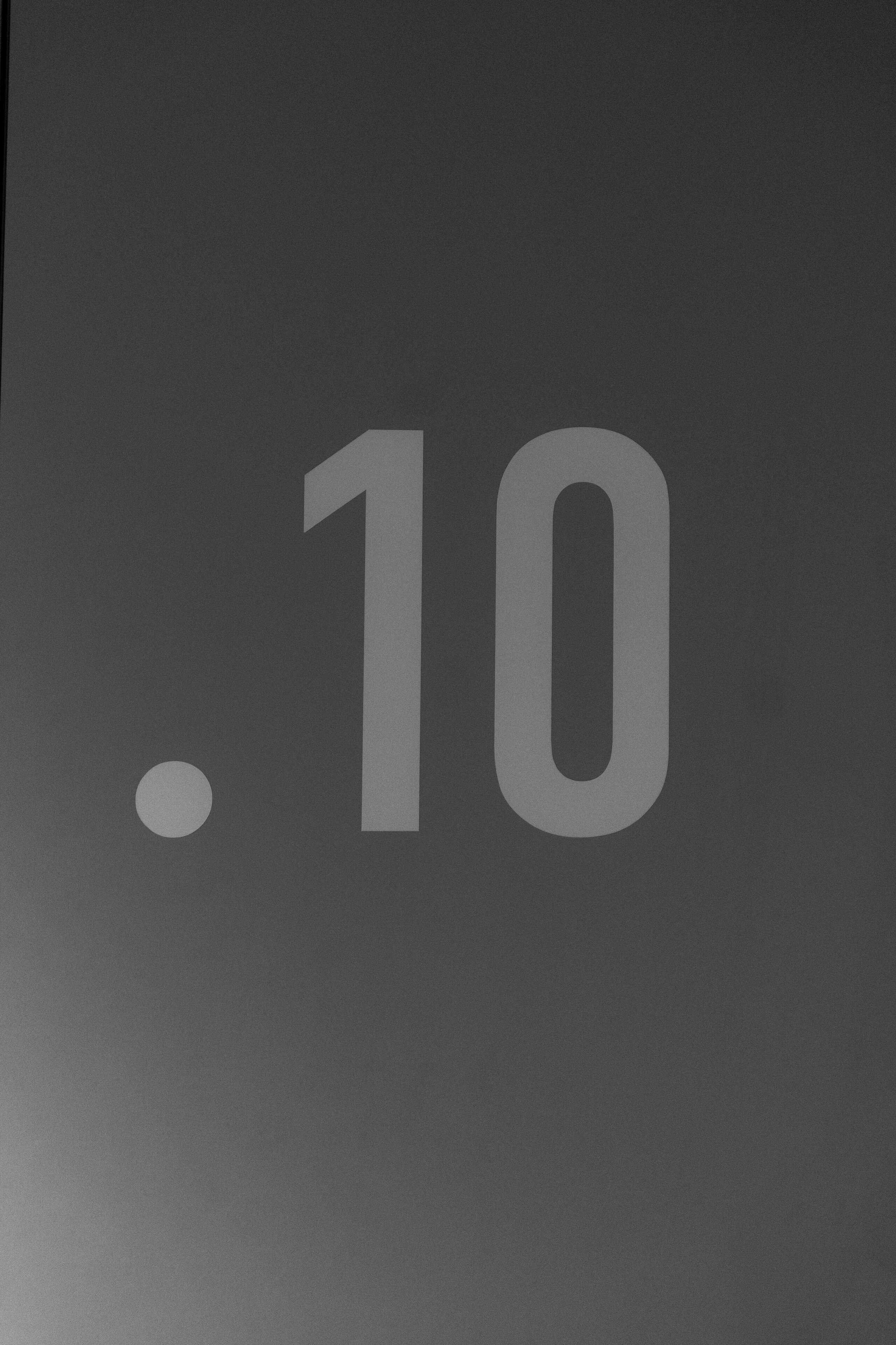A large, bold number "10" on a dark background.