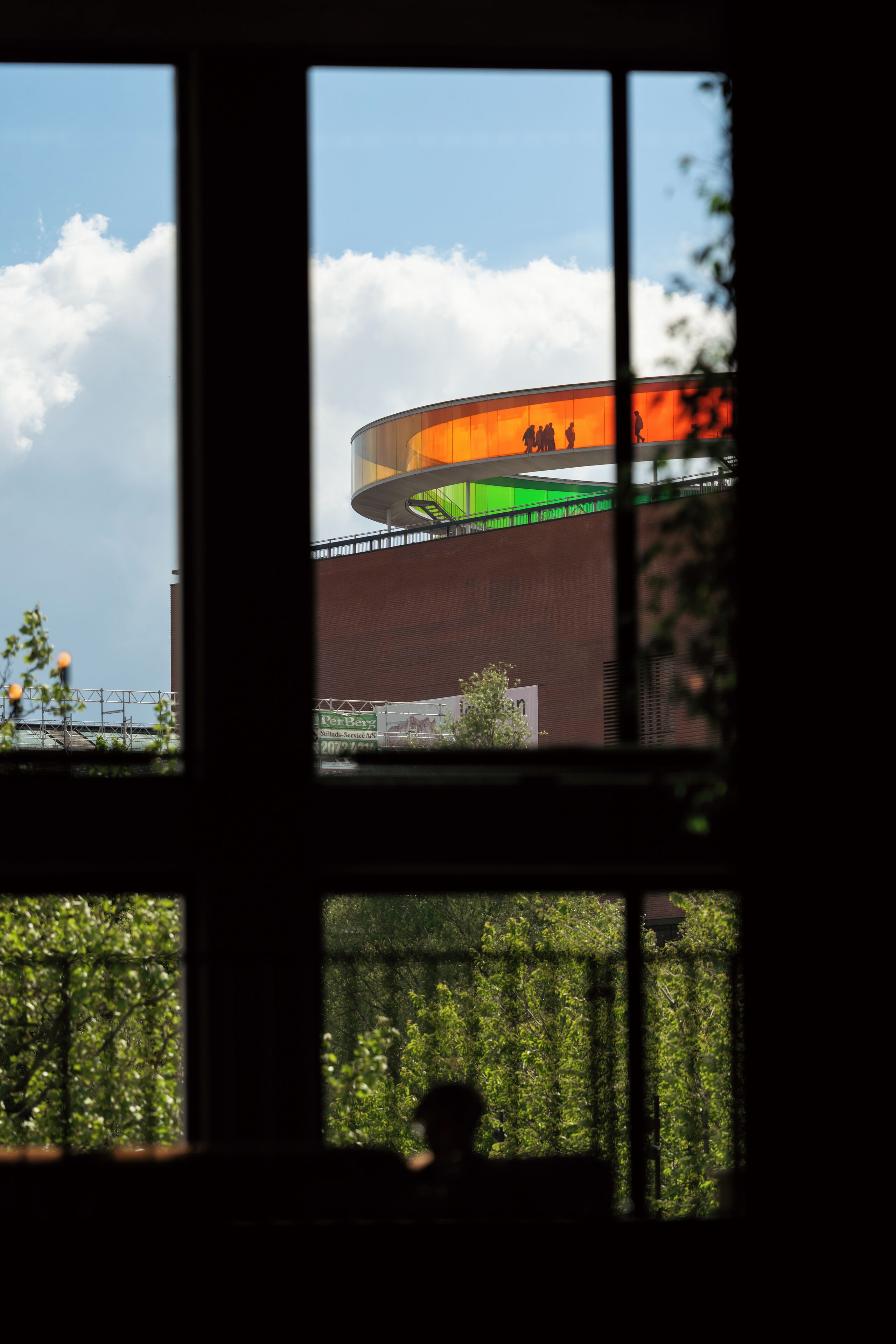 A view through a window with a building in the background.