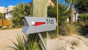 A mailbox with the number 316, surrounded by greenery and a clear sky. - Tiny Beach Boardwalk Bungalow D | Rooftop Retreat (Fort Walton Beach)