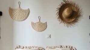 A bed with two pillows and a wall-mounted decorative item. - A 2 pas du Beffroi, 2-4p Wifi, Parking (Boulogne-sur-Mer)