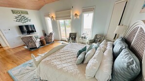 A bedroom with a large bed, a television, and a sign that reads "Beach House". - St Pete Beach Don Cesar Beachfront Hot Tub (St Pete Beach)