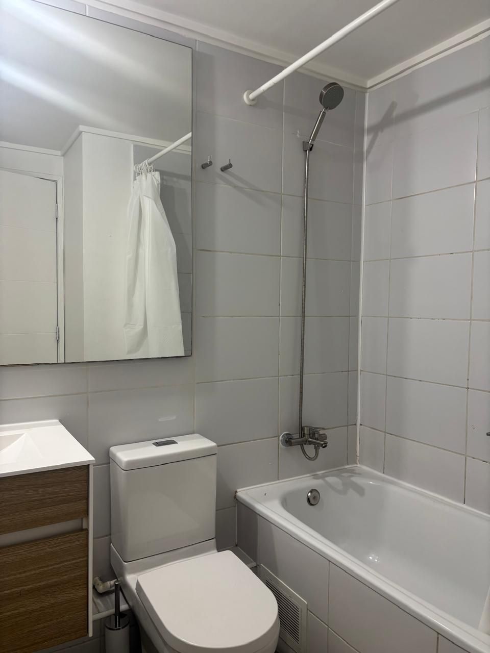 A bathroom with a toilet, sink, mirror, shower, and bathtub.